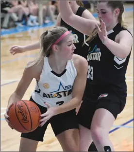  ??  ?? Haylee Baker, above, gets ready to whip a pass around twin sister, Olivia, during action Tuesday night in the annual North Central Ohio All-star Classic held at Cedar Point Sports Center in Sandusky. Haylee Baker, a junior at Shelby, was tabbed the Most Valuable Player in the Underclass Game as she helped Team White to a 56-42 victory over Team Black. Prior to the Underclass game a skills competitio­n was held and Shelby’s Sophia Niese, right, is shown competing.