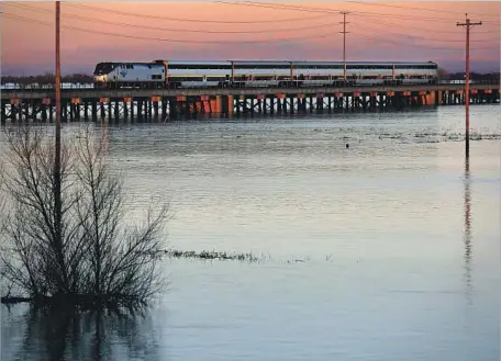  ?? Gary Coronado Los Angeles Times ?? THE YOLO BYPASS, at its top capacity, can handle five times as much water as can the narrow banks of the Sacramento River. “This whole city of Sacramento could not exist as it does without that bypass,” said an official with the California Natural...