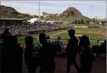  ?? DARRON CUMMINGS — THE ASSOCIATED PRESS ?? Fans watch a spring training game between the Angels and Padres on Feb. 27 in Tempe, Ariz.