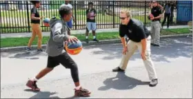  ?? MICHILEA PATTERSON — DIGITAL FIRST MEDIA ?? Kids play basketball with a couple of Pottstown police officers during the 2nd Annual Pottstown Community Field Day at Chestnut Street Park on Saturday.