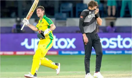  ?? Agence France-presse ?? ↑
Australia’s Mitchell Marsh (left) celebrates their win in the ICC Twenty20 World Cup final against New Zealand on Sunday.