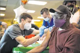  ?? Erik Verduzco Las Vegas Review-journal @Erik_verduzco ?? Otis Thrower, 76, receives the COVID-19 vaccine from Touro University Nevada physician assistant student Skyler Ellsworth at the Adult Day Care Center of Las Vegas on March 10. The positivity rate in Nevada has fallen to 5.5 percent.