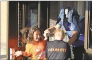  ?? Blake Doss / Rome News-Tribune ?? Ansley Fuqua (left) and Ryland Steen “drag” their “hiding” Principal Rodney Stewart out of the school to the ladder to get on the roof Friday for a fundraiser.