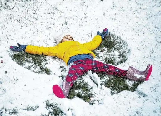  ?? PHOTO: MARK CONDREN ?? Fun time: A child makes a snow angel in Dublin yesterday.
