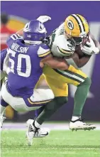  ?? GETTY IMAGES ?? Green Bay Packers running back Tyler Ervin is tackled by Minnesota Vikings linebacker Eric Wilson during last Monday night’s game at U.S. Bank Stadium.