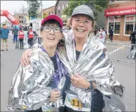  ?? MITCH MACDONALD/THE GUARDIAN ?? Joan Murchison, left, and BJ Willis are all smiles after finishing the 14th annual P.E.I. Marathon on Sunday. The event was the first full marathon for Murchison, who recently turned 60-years-old and decided it was “now or never.”