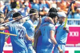  ?? AFP ?? Harmanpree­t Singh (second from right) is congratula­ted by teammates after scoring his second goal against Malaysia on Tuesday. India won 21.