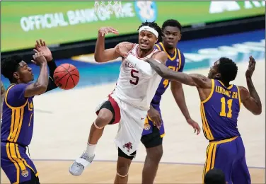  ?? Associated Press ?? Loose ball: Arkansas' Moses Moody (5) loses the ball as he drives against LSU's Josh LeBlanc Sr. (11) in the second half in the Southeaste­rn Conference Tournament Saturday in Nashville, Tenn.