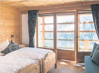  ??  ?? A room with a boutique-hotel feel at the Rifugio Col Pradat inn in the Dolomites.