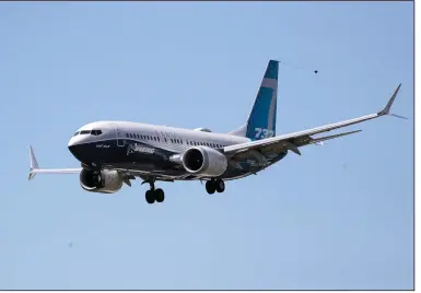  ?? (AP) ?? A Boeing 737 Max jet heads to a landing at Boeing Field in Seattle after a test flight in June.