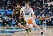  ?? Matt Freed/Associated Press ?? Creighton’s Baylor Scheierman (55) drives around Oregon’s Jadrian Tracey (22) in the second round of the NCAA men’s tournament on Saturday.