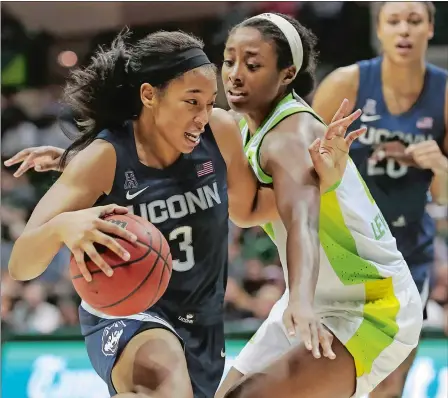  ?? MIKE CARLSON/AP PHOTO ?? UConn’s Megan Walker, left, drives past South Florida’s Shae Leverett during the second half of a game on Sunday, Feb. 16, in Tampa, Fla. Walker a junior forward and the 2020 American Athletic Conference Player of the Year, announced Saturday she is leaving UConn a year early to enter next month’s WNBA draft.