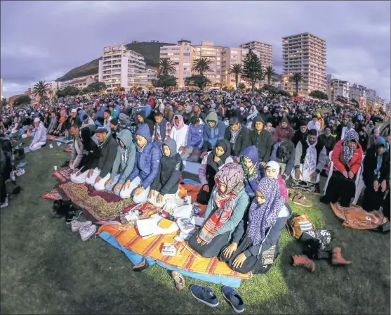  ?? Picture: EPA/NIC BOTHMA ?? Muslims pray during the sighting of the moon, gathering at the end of the Islamic holy month of Ramadaan in Cape Town. This marks the beginning of Eid al-Fitr, at the end of Ramadaan – the holiest month in the Islamic calendar.