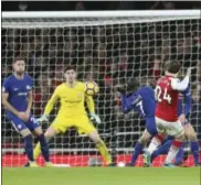  ?? ADAM DAVIS — THE ASSOCIATED PRESS ?? Arsenal’s Hector Bellerin, right, scores against Chelsea late in the second half Wednesday.