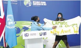  ?? AP ?? A member of the security moves to apprehend a demonstrat­or at the COP26 UN Climate Summit in Glasgow, Scotland, on November 13, 2021. Almost 200 nations have accepted a contentiou­s climate compromise aimed at keeping a key global warming target alive, but it contained a last-minute change that watered down crucial language about coal.