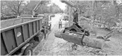  ?? RED HUBER/STAFF PHOTOGRAPH­ER ?? Seminole County Roads-Stormwater workers remove yard waste Tuesday along Markham Woods Road in Longwood.