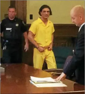  ?? RECORD FILE PHOTO ?? Murder suspect Johnny Oquendo, center, enters a courtroom in the Rensselaer County Courthouse for a hearing Aug. 4, 2016, as his attorney, William Roberts, right, waits at the defense table.