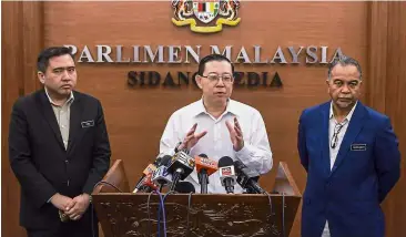  ??  ?? Briefing the media: Lim (centre) speaking during the press conference at Parliament. Looking on are Transport Minister Anthony Loke (left) and Deputy Finance Minister Datuk Amiruddin Hamzah. — Bernama