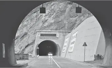  ??  ?? In this photograph, Pakistani commuters travel at a newly built tunnel in northern Pakistan’s Gojal Valley. A glossy highway and hundreds of lorries transporti­ng Chinese workers by the thousands: the new Silk Road is under constructi­on in northern...