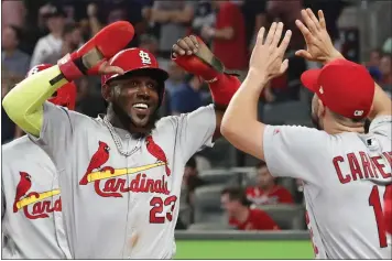  ?? JOHN BAZEMORE – THE ASSOCIATED PRESS ?? St. Louis Cardinals left fielder Marcell Ozuna, left, celebrates his ninth-inning, two-run double with Matt Carpenter.