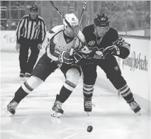  ?? GETTY IMAGES ?? Washington’s Evgeny Kuznetsov, left, goes up against Pittsburgh’s Jake Guentzel during second-round action. With nine goals and 14 points, Guentzel has been the Pens’ unsung hero in the playoffs.