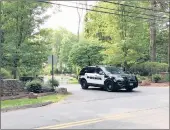  ?? PETER MARTEKA/HARTFORD COURANT ?? A Farmington Police car leaves the Jefferson Crossing home of Fotis Dulos, the husband of missing Jennifer Farber Dulos, on Saturday morning.