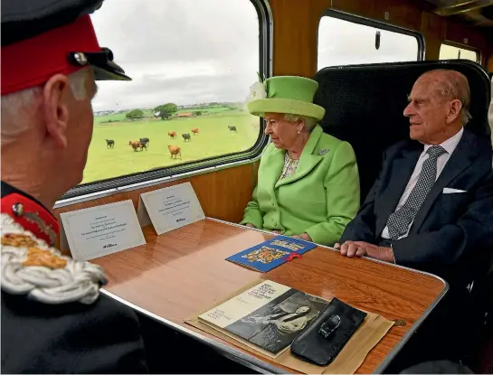  ?? PHOTO: REUTERS ?? The Queen and the Duke of Edinburgh travel by steam train from Coleraine to Bellarena during their two-day visit to Northern Ireland.