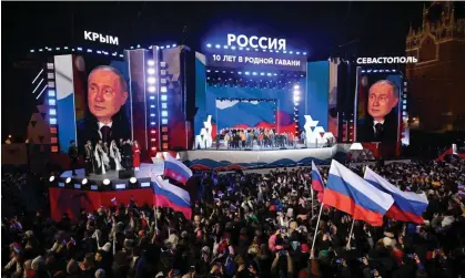  ?? Photograph: Natalia Kolesnikov­a/AFP/Getty Images ?? ‘Putin’s election was a rerun of his 2014 Sochi Winter Olympics, a global dressing-up, a rallying of support.’ Vladimir Putin addresses a crowd at a rally in Moscow on 18 March.