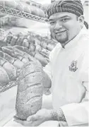  ??  ?? Production manager Julius Rodriguez displays some rye bread. Three Brothers Bakery recently was named Retail Bakery of the Year by Modern Baking.