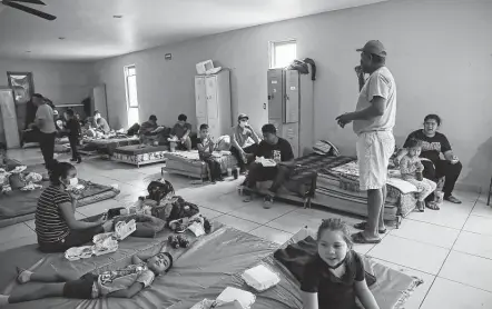  ?? Photos by Jerry Lara / Staff photograph­er ?? Pastor Hector Lira announces the opening of a clinic to migrant families in quarantine at Senda de Vida shelter in Reynosa, Mexico.