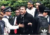  ??  ?? A resident reacts with anger close to the scene of the blaze. Authoritie­s are being blamed for not ensuring proper building standards were in force at the tower block that housed mainly immigrants. PICTURE: EPA