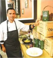  ??  ?? VA BENE Pasta Deli executive chef and owner Massimo Veronesi stands beside a display of Oliviers&Co. olive oils.