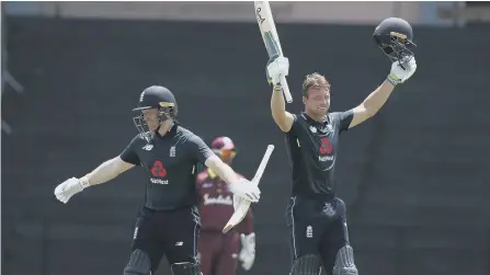  ??  ?? England’s Jos Buttler, right, celebrates with captain Eoin Morgan after reaching his century against West Indies.