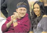  ?? SAM CRAFT/ASSOCIATED PRESS ?? Former Texas A&amp;M quarterbac­k Johnny Manziel, who said he has struggled with mental illness, sits with his fiancé, Bre Tiesi, during an NCAA basketball game on Saturday.