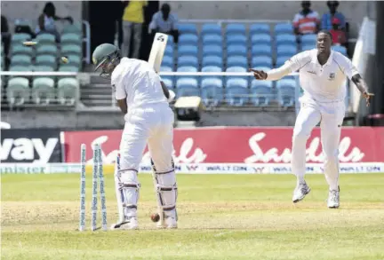  ??  ?? Bangladesh captain Shakib Al Hasan (left) looks back at his stumps after being bowled by his West Indian counterpar­t Jason Holder, during day two action in the second Test at Sabina Park in this 2018 file photo.