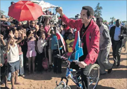  ?? Photo: Marco Longari/AFP ?? Populist move: President Ian Khama rides a bicycle while campaignin­g in Gaborone in 2014. But the gap between the people and the president has never been wider.