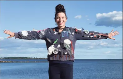  ?? Arnold Gold / Hearst Connecticu­t Media ?? Forest School third-grade teacher Stacey Giaquinto is photograph­ed on the beach in West Haven on Sept. 29, with a sweatshirt covered with single-use plastics that she wears for class lessons on the topic.