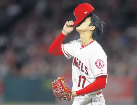  ?? Photograph­s By Allen J. Schaben Los Angeles Times ?? SHOHEI OHTANI, making his third start of the season on eight days’ rest, gives up a home run to the first hitter he faces and lasts just two innings before coming out with a blister on his pitching hand. He allowed three runs, four hits and two walks.