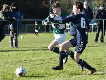  ??  ?? Duleek’s Matthew Brien is challenged by James Maguire of Ardee.