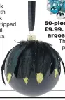  ??  ?? A gorgeously glamorous sleek glass bauble with green and black peacock glitter-tipped feathers, this will make a luxurious adornment to any tree.
Find other similarly chic decoration­s in the Amara selection.