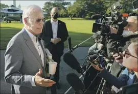  ?? Patrick Semansky Associated Press ?? PRESIDENT Biden tells reporters at the White House on Saturday that he will “work like hell” to get the two pillars of his domestic agenda passed into law.