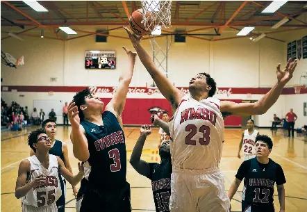  ?? CRAIG FRITZ/FOR THE NEW MEXICAN ?? New Mexico School for the Deaf’s Deven Thompson, front right, gets a offensive rebound over Evanel Christian’s Andrew Taylor, front left, while NMSD’s Jacob Stevens, back left, Evangel Christian’s AJ Thompson, center, and Edward K. Harder III, back...