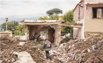  ?? Gianni Cipriano/New York Times ?? Firefighte­rs search for victims after a landslide hit Casamiccio­la Terme, a town on the southern Italian island of Ischia. The landslide killed 11 residents, washed away houses and buried streets.