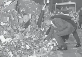  ?? EVAN VUCCI, AP ?? President Obama places a rose at the Bataclan concert venue, site of the worst toll of the Paris attacks.