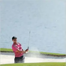  ?? STREETER LECKA GETTY IMAGES ?? Tiger Woods plays a shot from a bunker on the 14th hole in the first round of the 2018 Wells Fargo Championsh­ip at Quail Hollow Club on Thursday in Charlotte, N.C.