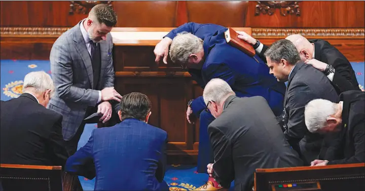  ?? ANDREW HARNIK / ASSOCIATED PRESS ?? Members of Congress pray Jan. 6 in the House chamber in Washington.