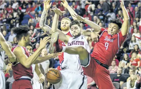  ?? BOB TYMCZYSZYN/ STANDARD STAFF ?? The Brock University men's basketball team faces the No. 1- ranked Carleton Ravens at Meridian Centre in St. Catharines Saturday. Mitch Jackson ( 15) battles with Brock players Kascius Small- Martin ( 9), Dani Elgadi ( 13) and Cassidy Ryan ( 35) in the...