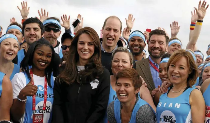  ?? PHOTO: LUKE MACGREGOR/AP ?? Prince William and Kate meet with members of the team Heads Together before officially starting the 2017 London Marathon.