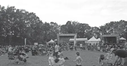  ?? PHOTOS BY ALIE SKOWRONSKI/COLUMBUS DISPATCH ?? It was a relaxed setting Friday at the Hocking Hills Music Festival, with children playing with the bands played.