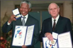  ?? ASSOCIATED PRESS ?? South African Deputy President F.W. de Klerk (right) and South African President Nelson Mandela pose with their Nobel Peace Prize Gold Medal and Diploma, in Oslo, Dec. 10, 1993.